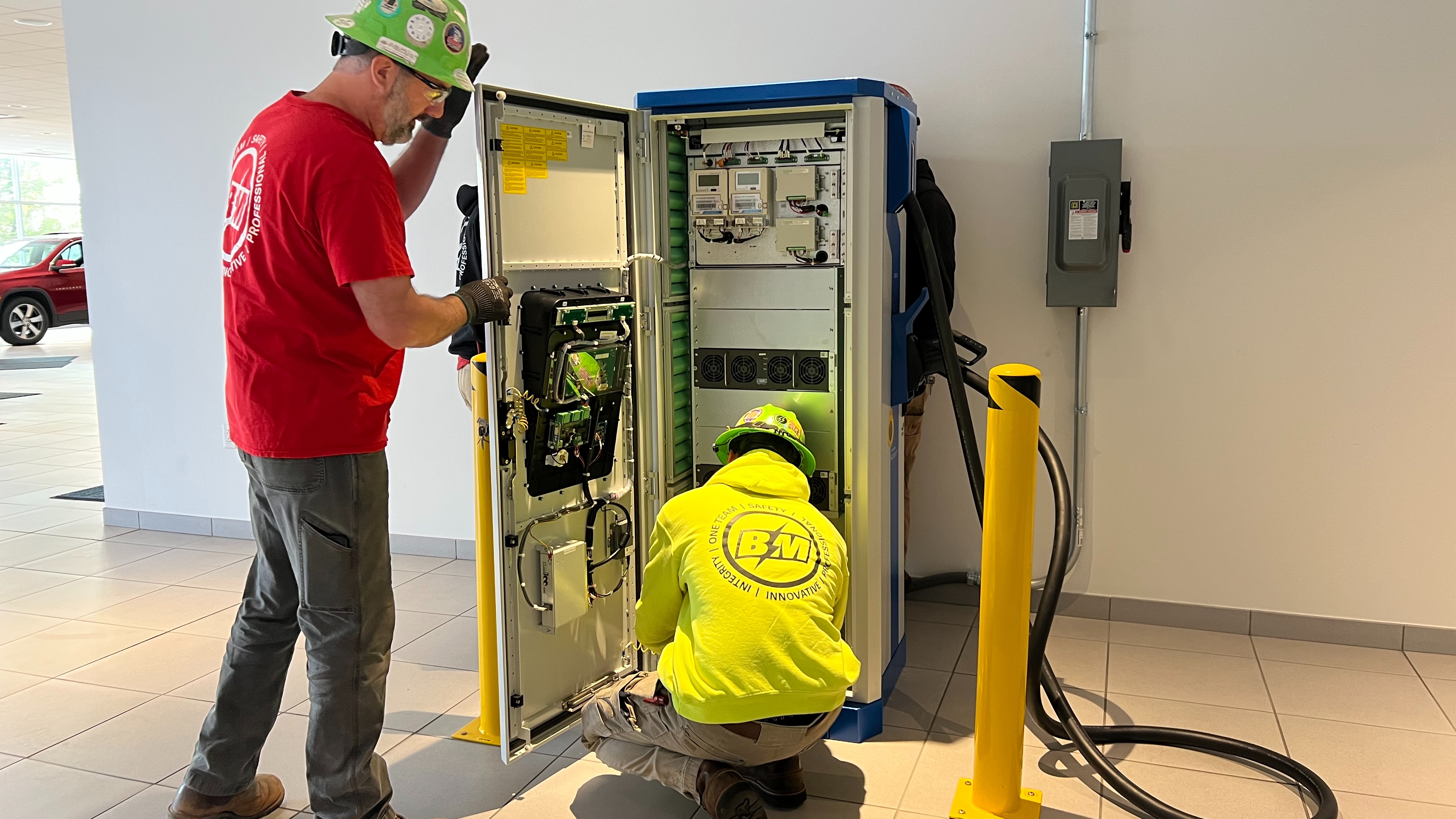 Union electricians inspect interior commercial EV charger 